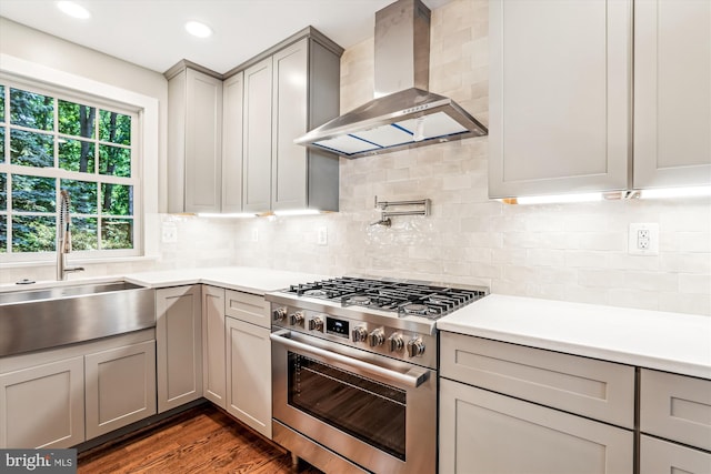 4711 Pontiac Dr, Annandale, VA 22003 - kitchen with wall chimney range hood, stainless steel stove, gray cabinetry, light countertops, and dark wood-style floors