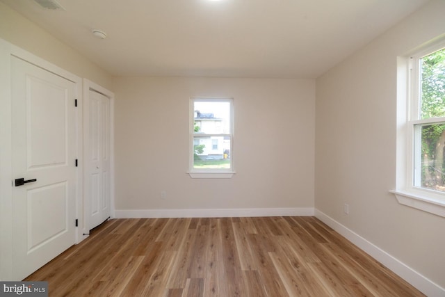 6827 Highland Ave, Pennsauken, NJ 08110 - unfurnished bedroom featuring light wood-style flooring and two closets