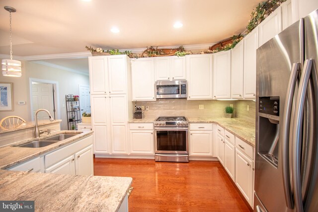 37126 Solitude Dr, Selbyville, DE 19975 - kitchen featuring stainless steel appliances, ornamental molding, white cabinetry, recessed lighting, and decorative backsplash