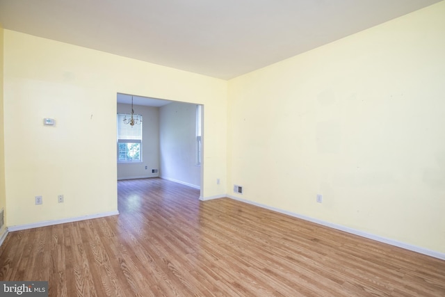 23 Navesink Dr, Pennington, NJ 08534 - empty room with light wood-type flooring and a chandelier