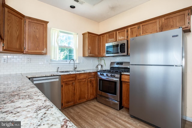 23 Navesink Dr, Pennington, NJ 08534 - kitchen with stainless steel appliances, light wood finished floors, and brown cabinets