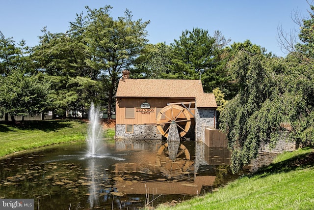 23 Navesink Dr, Pennington, NJ 08534 - view of front of property with a water view, a chimney, stone siding, and roof with shingles