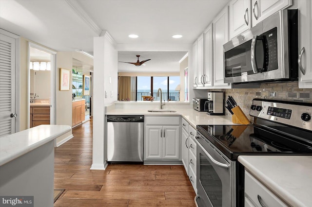 403 N Edgewater House Rd Unit 403N, Bethany Beach, DE 19930 - kitchen with appliances with stainless steel finishes, light wood finished floors, ornamental molding, light countertops, and white cabinets