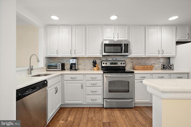 403 N Edgewater House Rd Unit 403N, Bethany Beach, DE 19930 - kitchen featuring stainless steel appliances, white cabinets, light countertops, light wood-style flooring, and recessed lighting
