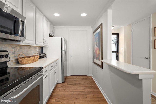 403 N Edgewater House Rd Unit 403N, Bethany Beach, DE 19930 - kitchen featuring appliances with stainless steel finishes, light wood finished floors, white cabinets, tasteful backsplash, and light countertops