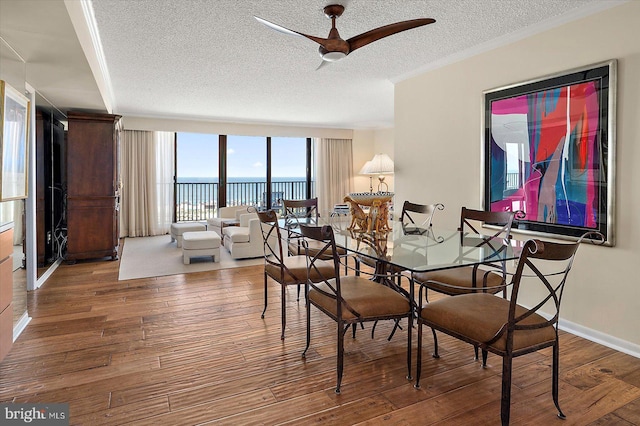 403 N Edgewater House Rd Unit 403N, Bethany Beach, DE 19930 - dining space featuring a textured ceiling, a ceiling fan, wood finished floors, a water view, and floor to ceiling windows