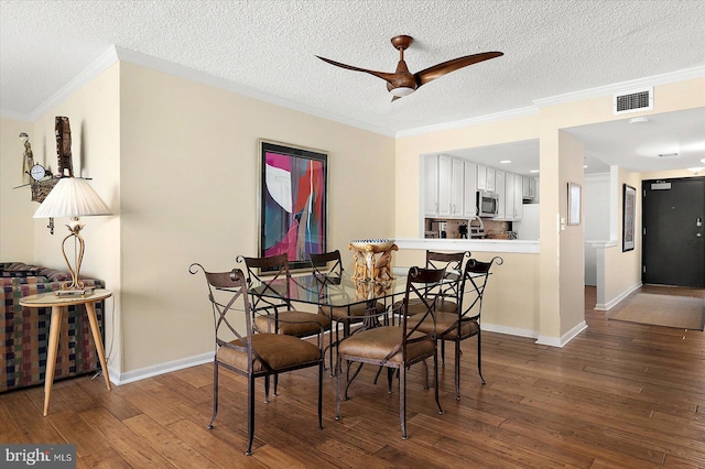 403 N Edgewater House Rd Unit 403N, Bethany Beach, DE 19930 - dining area featuring hardwood / wood-style flooring, a ceiling fan, a textured ceiling, and crown molding