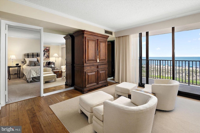 403 N Edgewater House Rd Unit 403N, Bethany Beach, DE 19930 - bedroom featuring dark wood-style flooring, access to outside, a water view, a textured ceiling, and crown molding