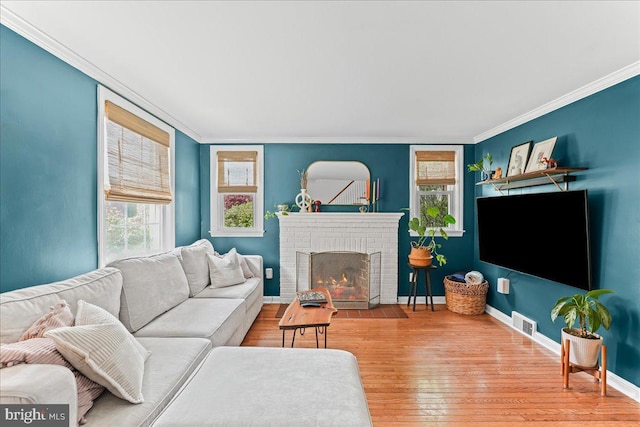 809 Addingham Ave, Drexel Hill, PA 19026 - living room featuring crown molding, wood finished floors, and a brick fireplace