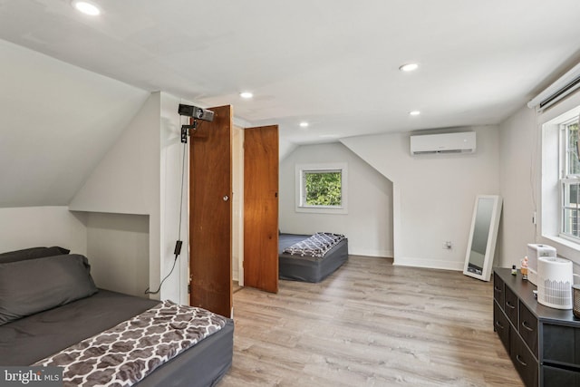 1707 Peach St, Upper Chichester, PA 19061 - bedroom with light wood finished floors, lofted ceiling, recessed lighting, and an AC wall unit