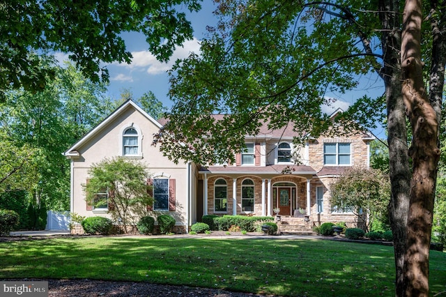 11204 Fawn Lake Pkwy, Spotsylvania, VA 22551 - view of front of property featuring a front lawn, stone siding, a porch, and stucco siding