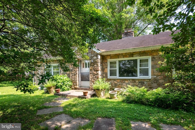 214 Sugartown Rd, Devon, PA 19333 - view of front of home featuring stone siding, a chimney, and a front yard