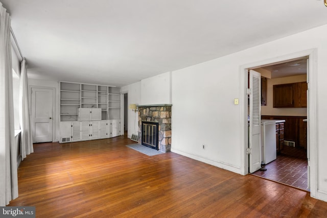 214 Sugartown Rd, Devon, PA 19333 - unfurnished living room with a fireplace, wood finished floors, and built in shelves