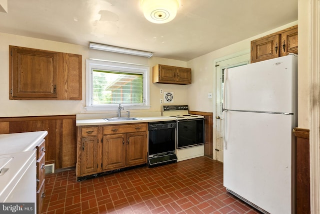 214 Sugartown Rd, Devon, PA 19333 - kitchen featuring freestanding refrigerator, dishwasher, electric range oven, brick patterned flooring, and brown cabinets