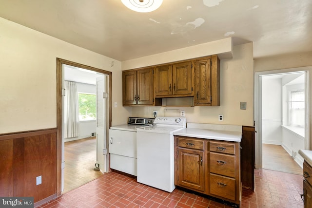 214 Sugartown Rd, Devon, PA 19333 - laundry area featuring cabinet space, brick patterned floors, and separate washer and dryer