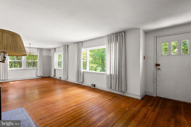 214 Sugartown Rd, Devon, PA 19333 - unfurnished living room with hardwood / wood-style floors and a chandelier