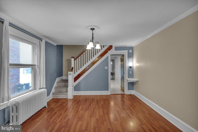 210 N Waverly St, Reading, PA 19607 - stairs featuring radiator, wood finished floors, a chandelier, and crown molding