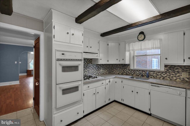 210 N Waverly St, Reading, PA 19607 - kitchen featuring white appliances, light tile patterned flooring, tasteful backsplash, ornamental molding, and white cabinets