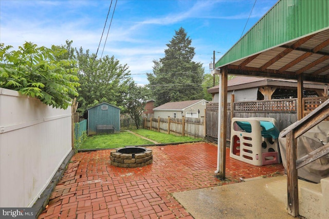 210 N Waverly St, Reading, PA 19607 - fenced backyard featuring an outdoor fire pit, a patio area, and a storage shed