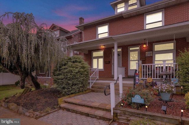 210 N Waverly St, Reading, PA 19607 - american foursquare style home featuring brick siding and covered porch