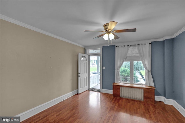 210 N Waverly St, Reading, PA 19607 - empty room featuring radiator heating unit, a ceiling fan, wood finished floors, and ornamental molding