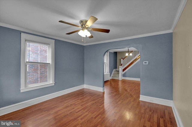 210 N Waverly St, Reading, PA 19607 - spare room featuring arched walkways, wood finished floors, a ceiling fan, stairway, and ornamental molding