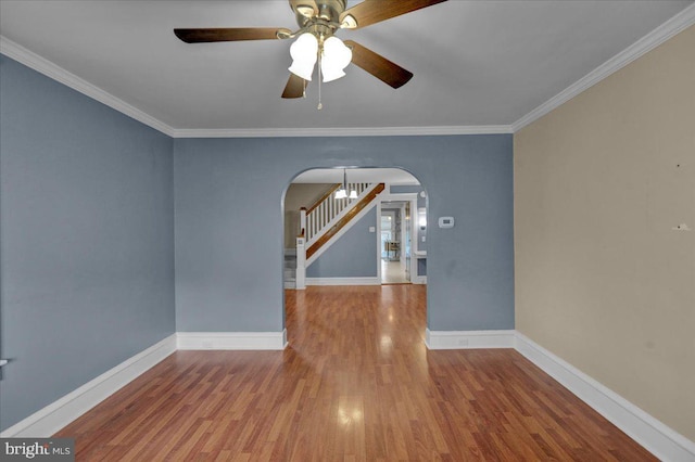210 N Waverly St, Reading, PA 19607 - unfurnished room with arched walkways, a ceiling fan, wood finished floors, crown molding, and stairs
