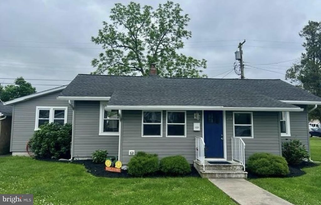 253 St, Carneys Point, NJ 08069 - view of front facade featuring a front lawn and a chimney