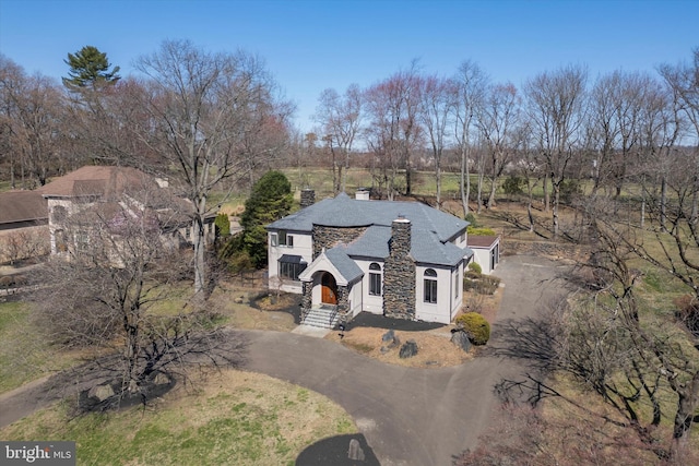 4127 Presidential Dr, Lafayette Hill, PA 19444 - view of front of house with asphalt driveway, stone siding, a chimney, and stucco siding