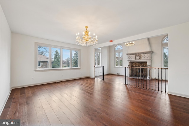 4127 Presidential Dr, Lafayette Hill, PA 19444 - unfurnished living room featuring a chandelier, hardwood / wood-style floors, and a large fireplace