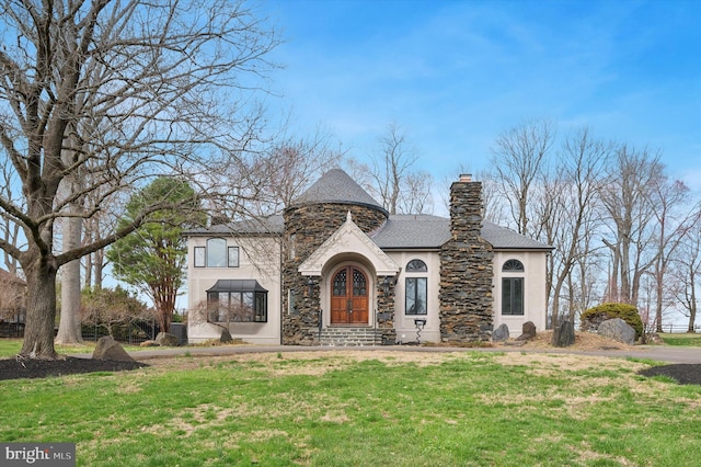 4127 Presidential Dr, Lafayette Hill, PA 19444 - french country style house featuring stone siding, stucco siding, a front lawn, a chimney, and a shingled roof