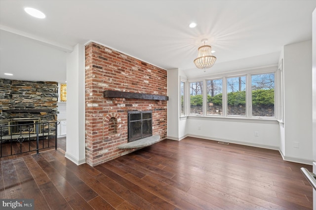 4127 Presidential Dr, Lafayette Hill, PA 19444 - unfurnished living room featuring a brick fireplace, wood-type flooring, a chandelier, and recessed lighting