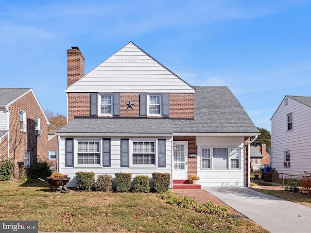 207 Commonwealth Ave, Claymont, DE 19703 - view of front of house with a chimney, brick siding, and a shingled roof