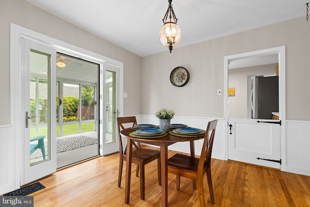 207 Commonwealth Ave, Claymont, DE 19703 - dining space with a wainscoted wall, light wood-type flooring, and a chandelier