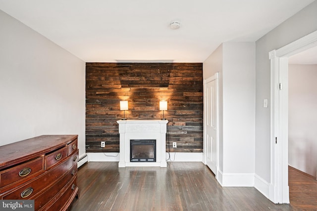 134 S Main St, Glassboro, NJ 08028 - unfurnished living room with a glass covered fireplace, wood finished floors, and baseboard heating