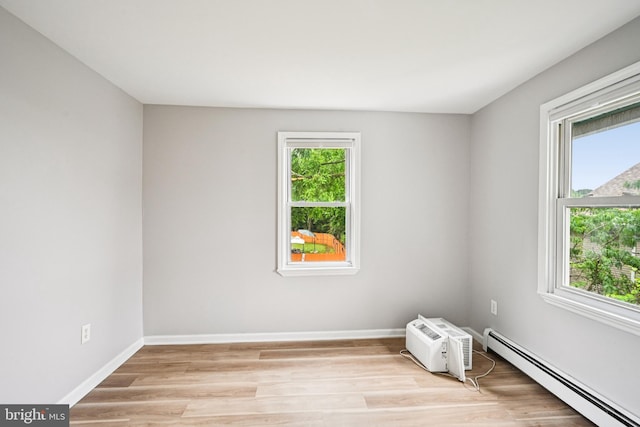 134 S Main St, Glassboro, NJ 08028 - spare room featuring a baseboard heating unit, healthy amount of natural light, and light wood-style flooring