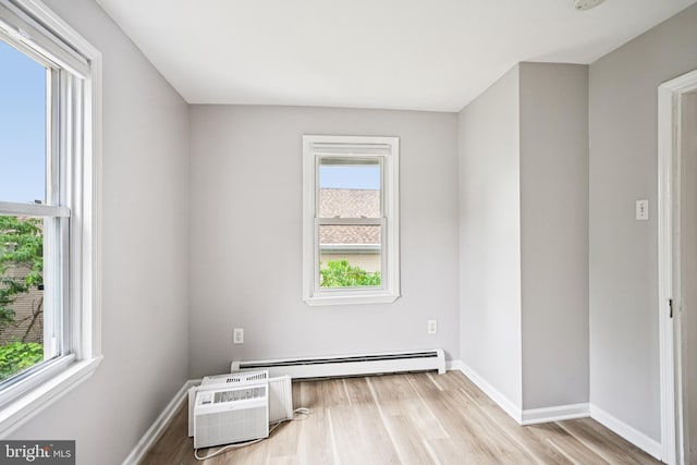 134 S Main St, Glassboro, NJ 08028 - spare room featuring a baseboard heating unit, wood finished floors, and a wall unit AC