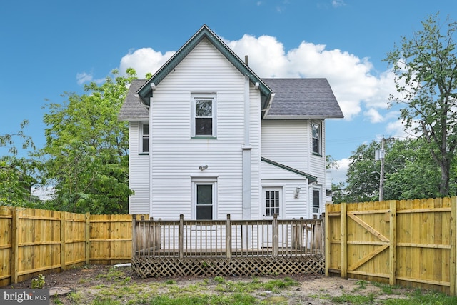 134 S Main St, Glassboro, NJ 08028 - back of property featuring roof with shingles, a deck, a gate, and a fenced backyard