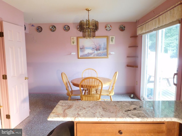 7799 Outing Ave, Pasadena, MD 21122 - carpeted dining room with a chandelier and baseboards
