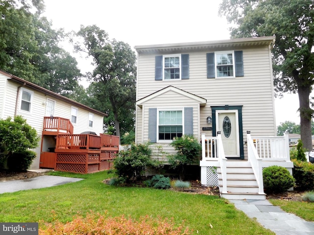 7799 Outing Ave, Pasadena, MD 21122 - townhome / multi-family property with a front yard and a wooden deck