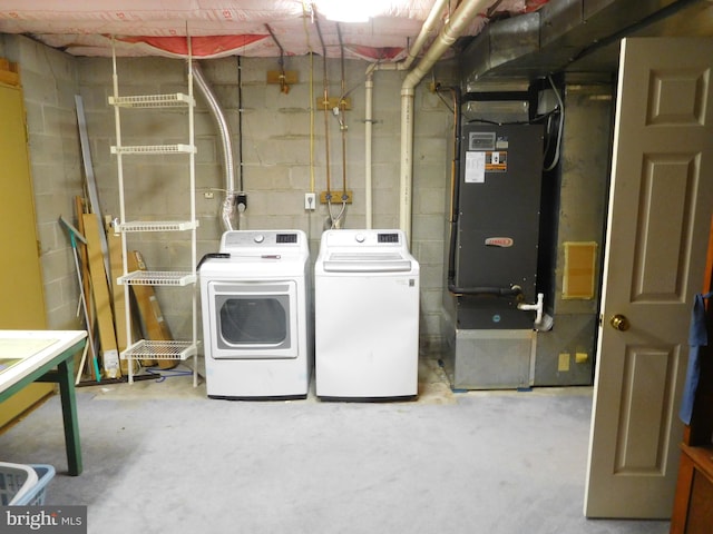 7799 Outing Ave, Pasadena, MD 21122 - laundry room featuring independent washer and dryer, concrete block wall, and heating unit