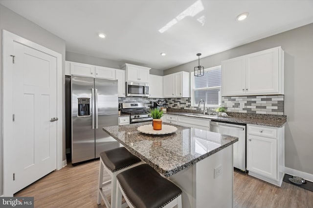 92 Senators Way, Berlin, NJ 08009 - kitchen featuring appliances with stainless steel finishes, backsplash, white cabinetry, light wood-type flooring, and recessed lighting