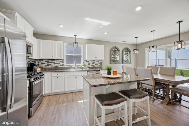 92 Senators Way, Berlin, NJ 08009 - kitchen with stainless steel appliances, decorative backsplash, light wood-style floors, a kitchen island, and recessed lighting