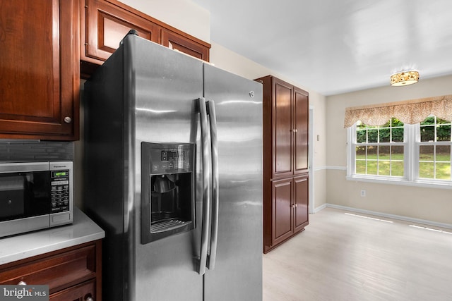 24411 Kakae Dr, Damascus, MD 20872 - kitchen with stainless steel appliances, light wood-style flooring, backsplash, and light countertops