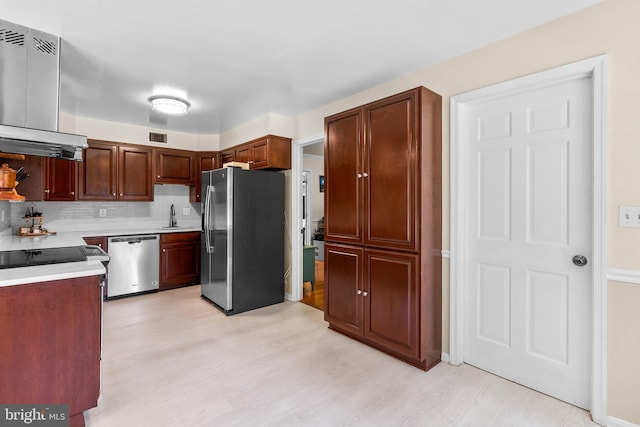 24411 Kakae Dr, Damascus, MD 20872 - kitchen featuring stainless steel appliances, island exhaust hood, light wood-type flooring, light countertops, and decorative backsplash