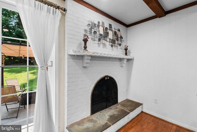 24411 Kakae Dr, Damascus, MD 20872 - unfurnished living room featuring beam ceiling, plenty of natural light, wood finished floors, and a fireplace