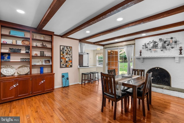 24411 Kakae Dr, Damascus, MD 20872 - dining room with light wood-style floors, beam ceiling, a brick fireplace, and recessed lighting