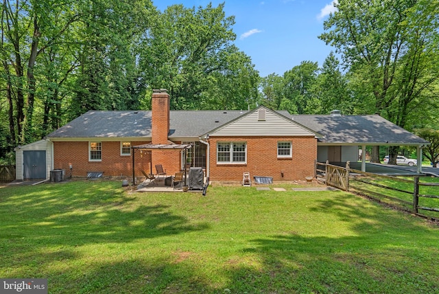 24411 Kakae Dr, Damascus, MD 20872 - back of property with a patio area, brick siding, a chimney, a shed, and an attached carport