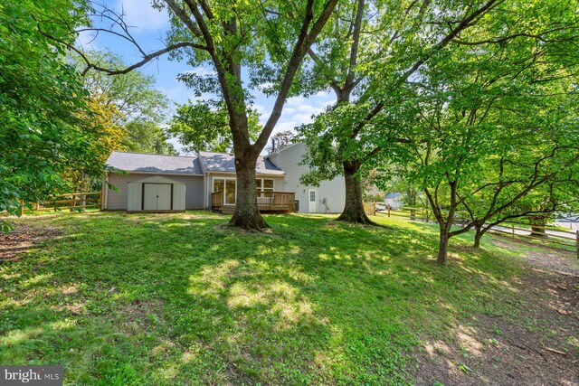 11013 Lopa Ln, North Potomac, MD 20878 - view of yard with a wooden deck and a storage unit