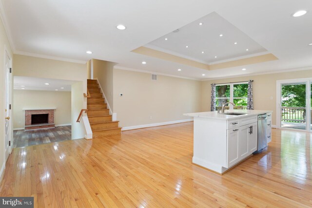 11013 Lopa Ln, North Potomac, MD 20878 - kitchen with open floor plan, a fireplace, light wood finished floors, white cabinetry, and dishwasher